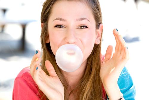 Young Girl Blowing A Bubblegum