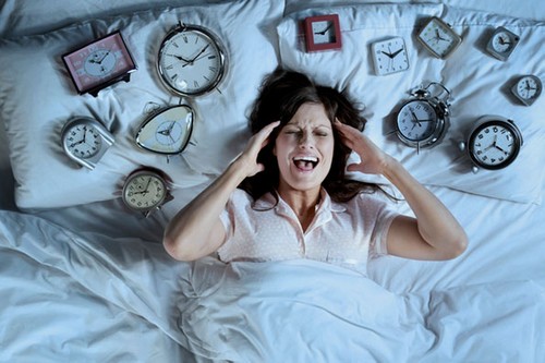 woman surrounded by clocks