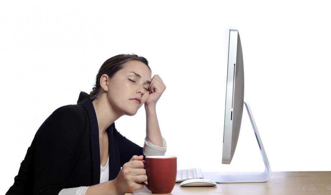 Woman sleeping at her desk at work