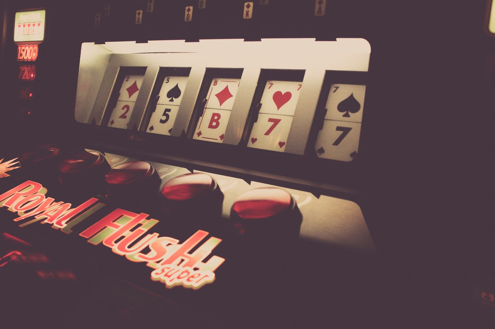 A slot machine with playing cards on it